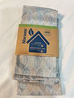 Front view showing Norwex band and leaf patterned napkins