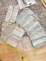 overview of all seven light gray packing cubes and pouches on floor