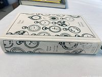 Spine and fore-edge view showing cloth pattern, title, author, ribbon bookmark