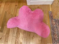 Front view showing overall shape and color of pink backrest pillow