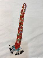 Full view of entire necklace showing length and pendant fringe