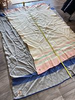 Both blankets laid out showing size and pattern; tape measure for dimensions