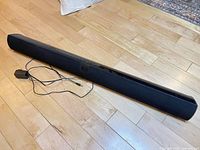 Full view of VIZIO VSB200 soundbar with attached power adapter