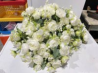 Stacked view of multiple white silk peony bouquets showing quantity and bloom detail