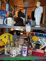 Shelf view showing figurine, mugs, Pepsi can, smile items, bear, memo pad