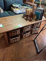 overview of pine coffee table top, wicker baskets visible in cubbies