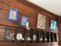 Overall view of wall shelf with collectibles and wall art