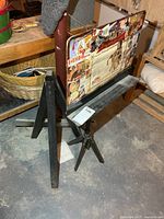 Tripod easel holding collage board, A-frame easel visible