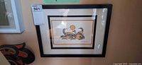 Framed giclée print hanging on wall showing artwork, matting and frame