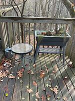 raised planter, side table, watering can on deck