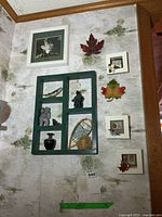 Full view of wall shelf, framed prints, maple leaves