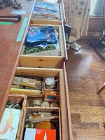 Open sideboard drawers showing linens and candles
