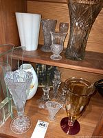 Shelf view showing multiple vases and candlesticks