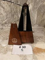 Metronome with cover removed showing pendulum, scale and wind-up key