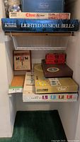 Board games and bells boxes on shelving