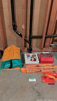 All items laid out: Big Jim figure, nylon fabric, booklet, bold eagle racer track pieces with box, TMNT lunch box
