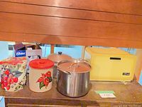 Group shot of bread box, two cookie tins and kettle box