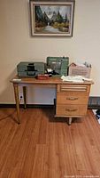 Front view of wooden mid-century desk showing drawers and legs