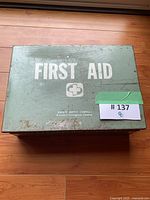 Top view showing FIRST AID text, brand mark and overall box