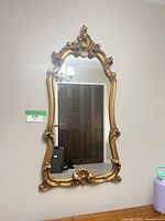 Front view of Pilkington giltwood mirror hanging on wall