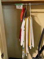 Group of folded linens hanging on closet rod