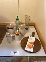 group shot of all items including four canisters, wasp catcher, smoked pitcher, pizza paddle