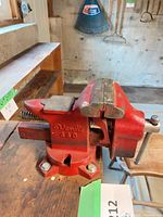 Overall view of Wenlic 440 red bench vise mounted on workbench
