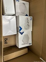 Box with multiple Bell and Hitron packages inside shipping carton