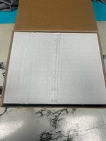 Open box showing stack of white envelopes