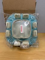 Top view of blue/beige puzzle feeder still in plastic