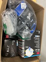 Open carton showing three 3M 10-pack N95 respirator boxes and sealed half-mask respirator