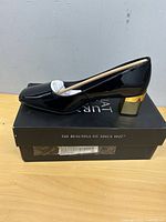 Side view of one pump on top of original box