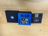 Closed presentation box with MAD logo and blue insert