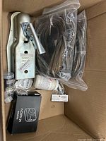Overview of box with trailer coupler, wiring harness, ABOX device, jar, small hardware