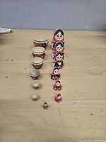 All five dolls opened and arranged from largest to smallest showing interiors and exteriors