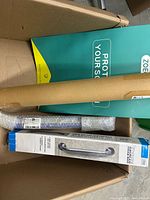 Box contents showing Protect Yourself sign board, mailing tube, grab bar box, bubble-wrapped roll