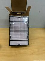 Box opened showing three individually wrapped rectangular filters