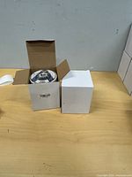 Open box showing stacked wool wheel discs and closed second box