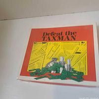 Front view of Defeat the TAXMAN board game box