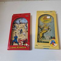 Both sealed Lone Ranger pinball games, red and yellow packages