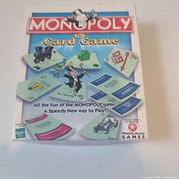 Front of Monopoly The Card Game box showing title, artwork, age rating, player count, Hasbro and Winning Moves logos