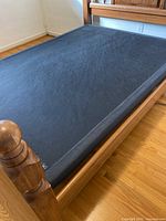 Adjustable base in lowered position inside oak frame