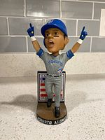 Front view of bobblehead showing uniform, base inscription and Hall of Fame plaque backdrop