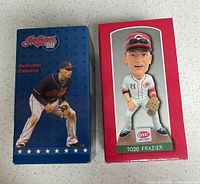 Front of both boxed bobbleheads showing player names and team branding