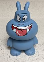 Front view of blue vinyl figure