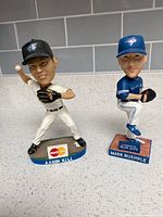 Aaron Hill and Mark Buehrle bobbleheads side by side
