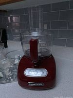 Front view of assembled red KitchenAid food processor