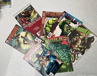 All seven comic books spread out showing covers