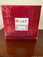 Front of sealed Maspar Colorart queen sheet set in red packaging