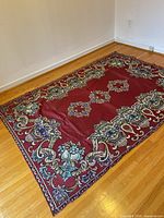 Full view of tapestry/tablecloth laid flat showing burgundy side and overall pattern